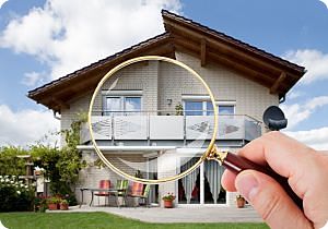 Two story home with person holding magnifying glass in front of home