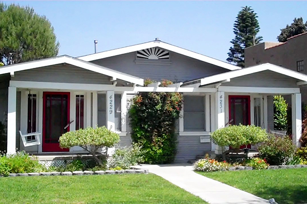 Beautiful red doored duplexes with freshly mowed lawn