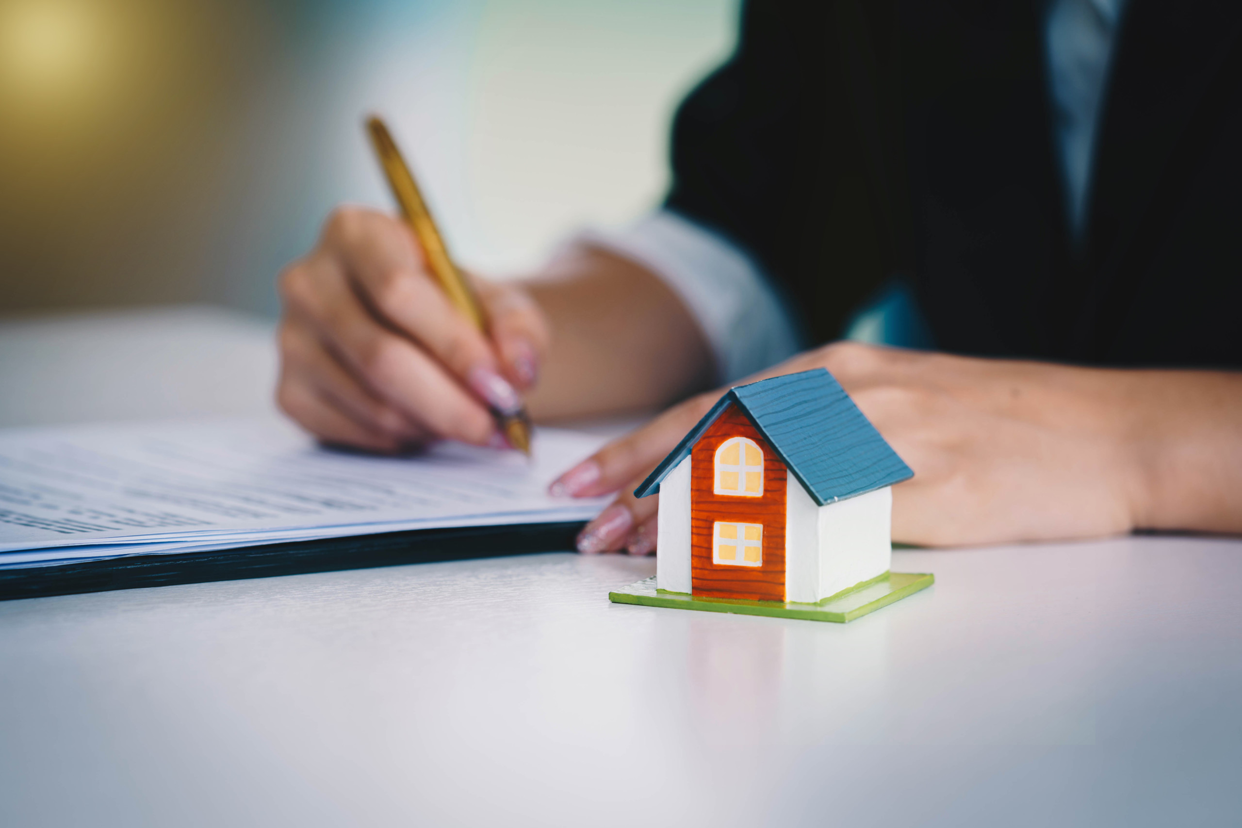 Businesswoman signing the document contract of a sale for a new house. Real estate services for buying your home. Loan for the purchase of housing.home loan and insurance concept.