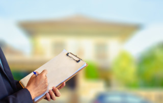 Man business salesman Sell house with computer On house and tree blurry background.For home business contracting or agreement and home warranty image