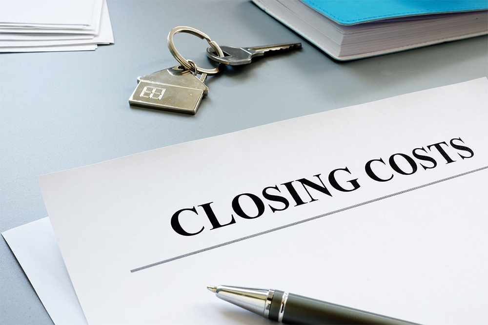 Paper with "Closing Costs" on top and keys in front of it