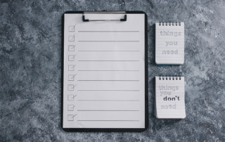 List with checkmarks and notepads beside it that read "things you need" and "things you don't need"
